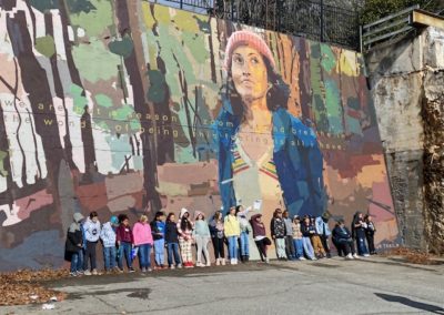 Academy at Elkin students in front of mural in Elkin, NC